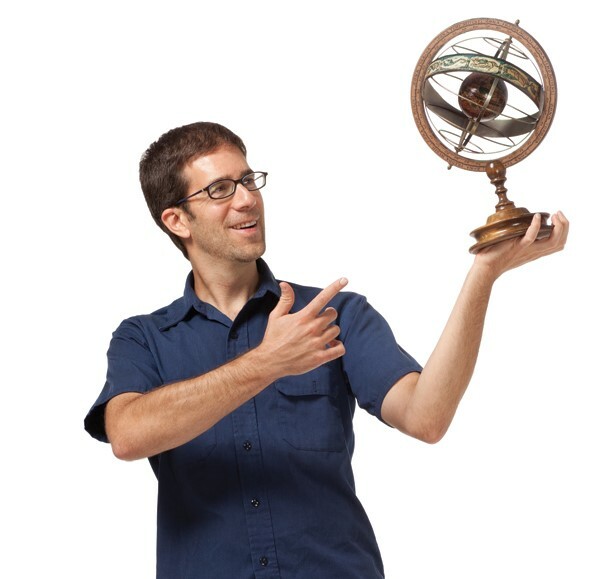 Dean Regas holding an armillary sphere